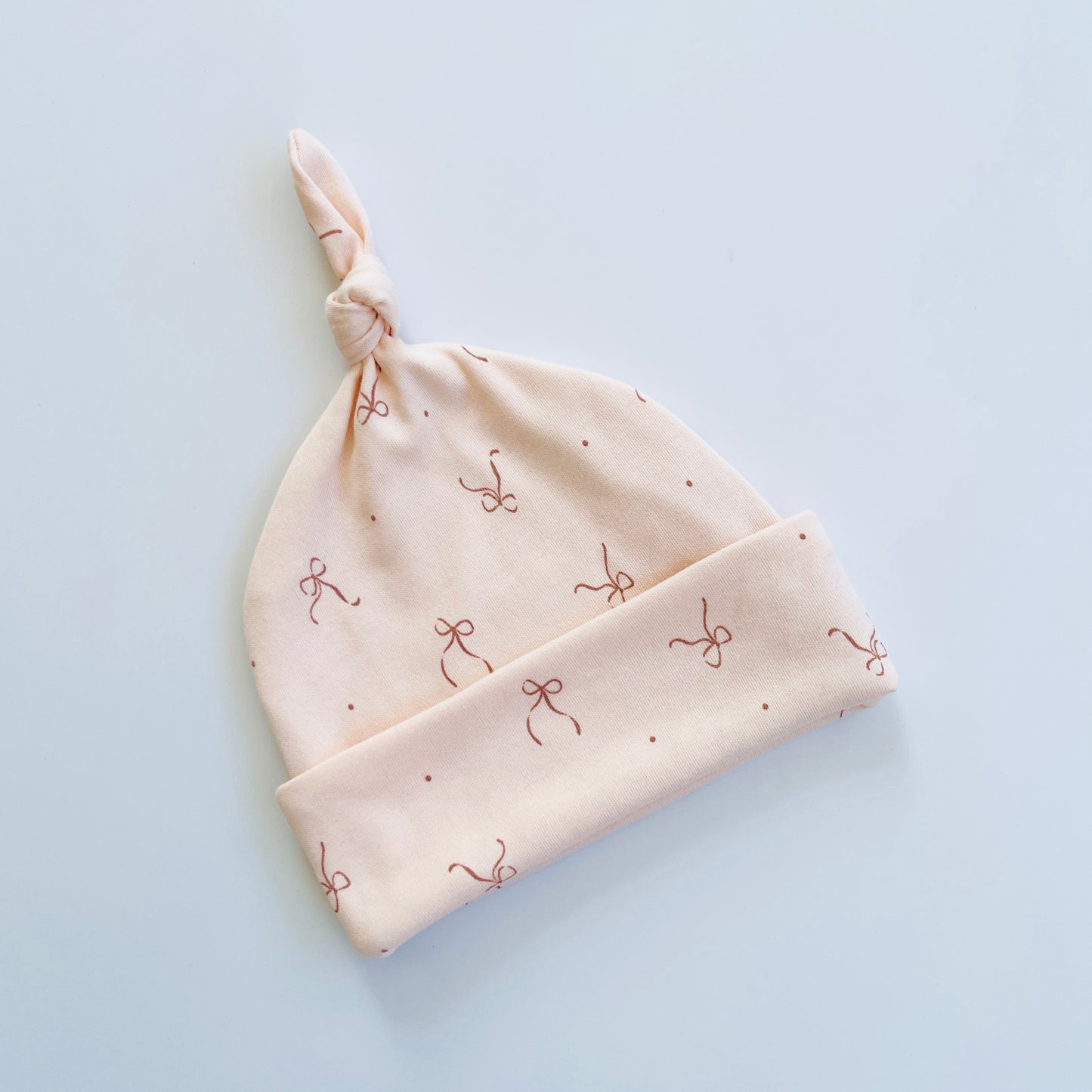 Soft Peach Colour Knotted Beanie with Bow Print