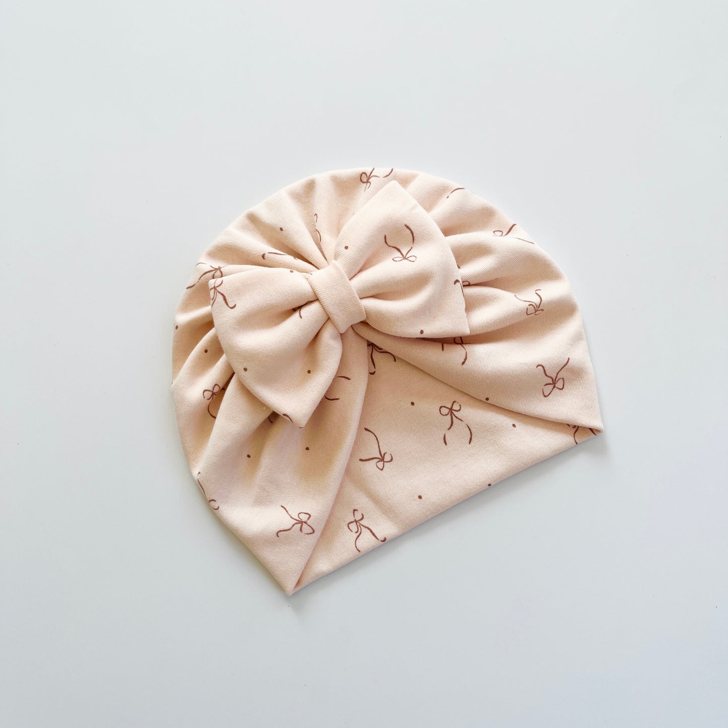 Bows Printed Light Peach Colour Baby Turban Hats in Bow, Flower & Donut Designs