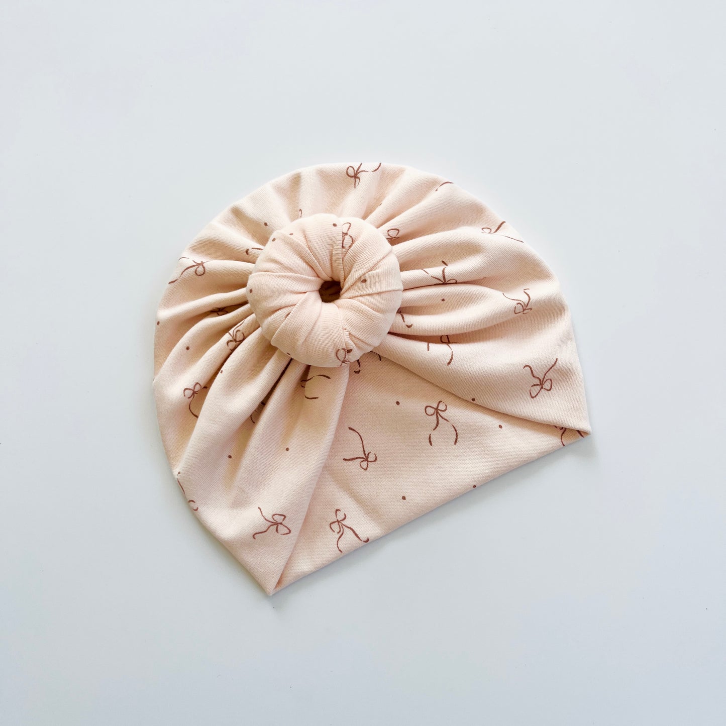 Bows Printed Light Peach Colour Baby Turban Hats in Bow, Flower & Donut Designs