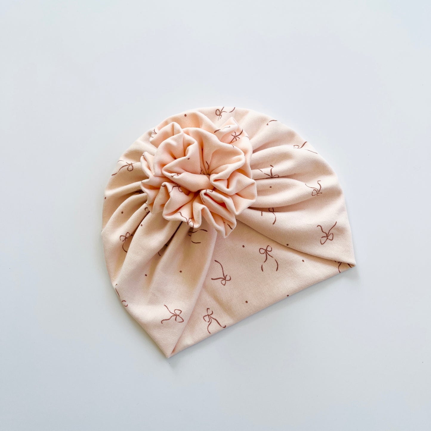 Bows Printed Light Peach Colour Baby Turban Hats in Bow, Flower & Donut Designs