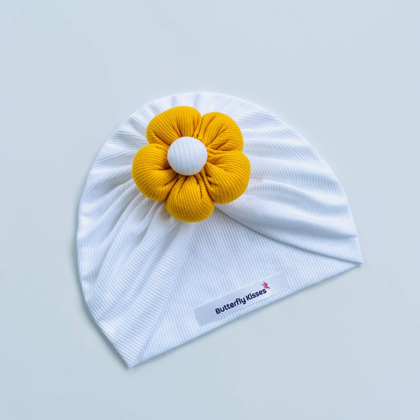 White Baby Turban with Puffy Flower in Red, Blue, Yellow & Pink