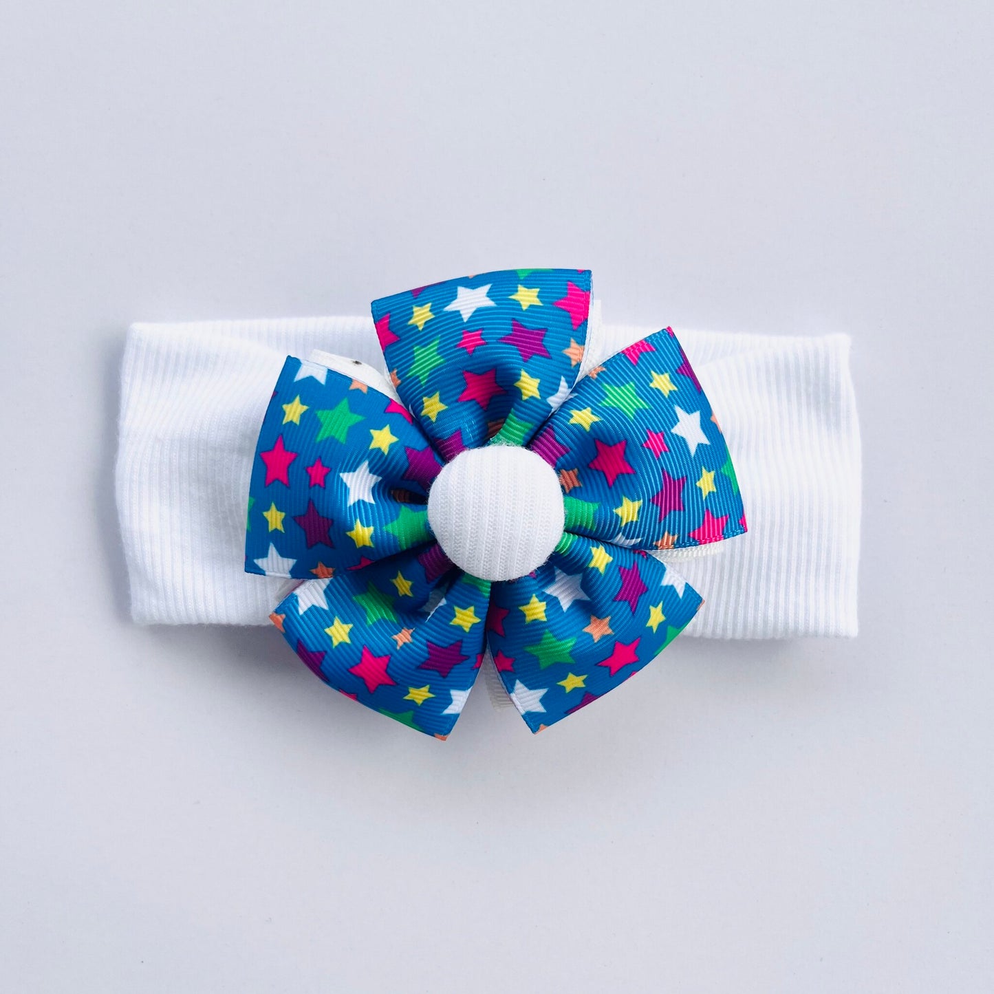 White Headband With Stars Printed Blue Ribbon Flower